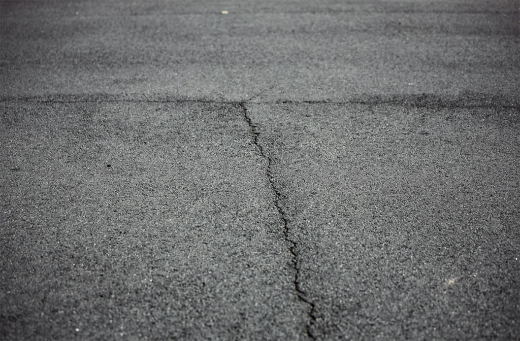 Close up of cracked asphalt pavement