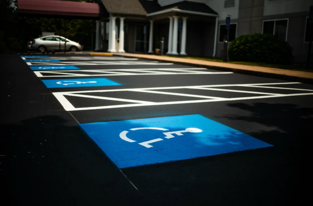 Proper line striping in commercial company parking lot showing ada compliant parking spaces